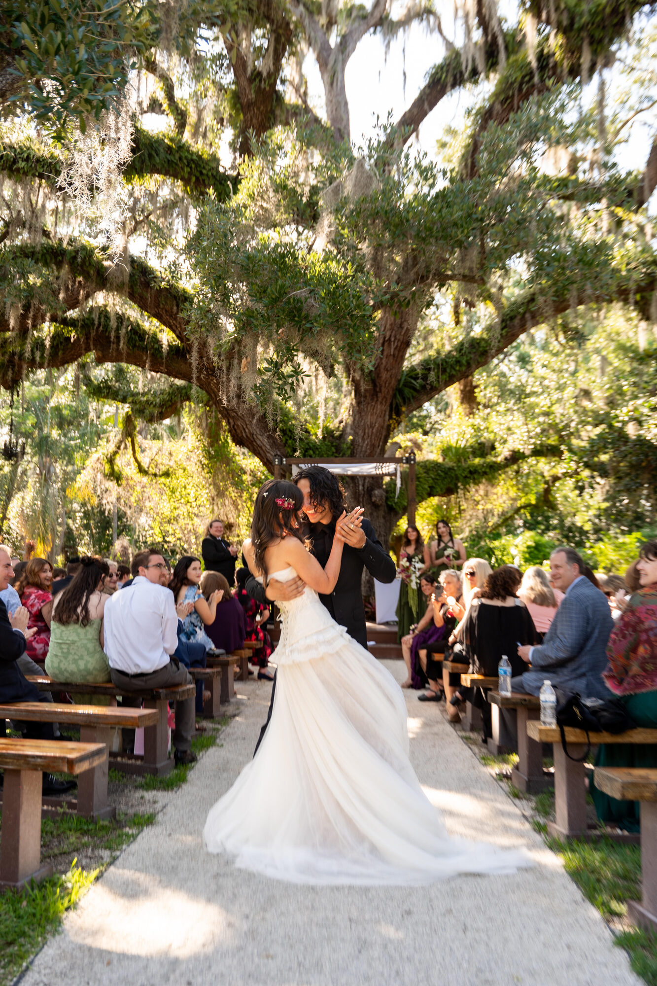 Bride and groom dancing barefoot in the sand at the reception