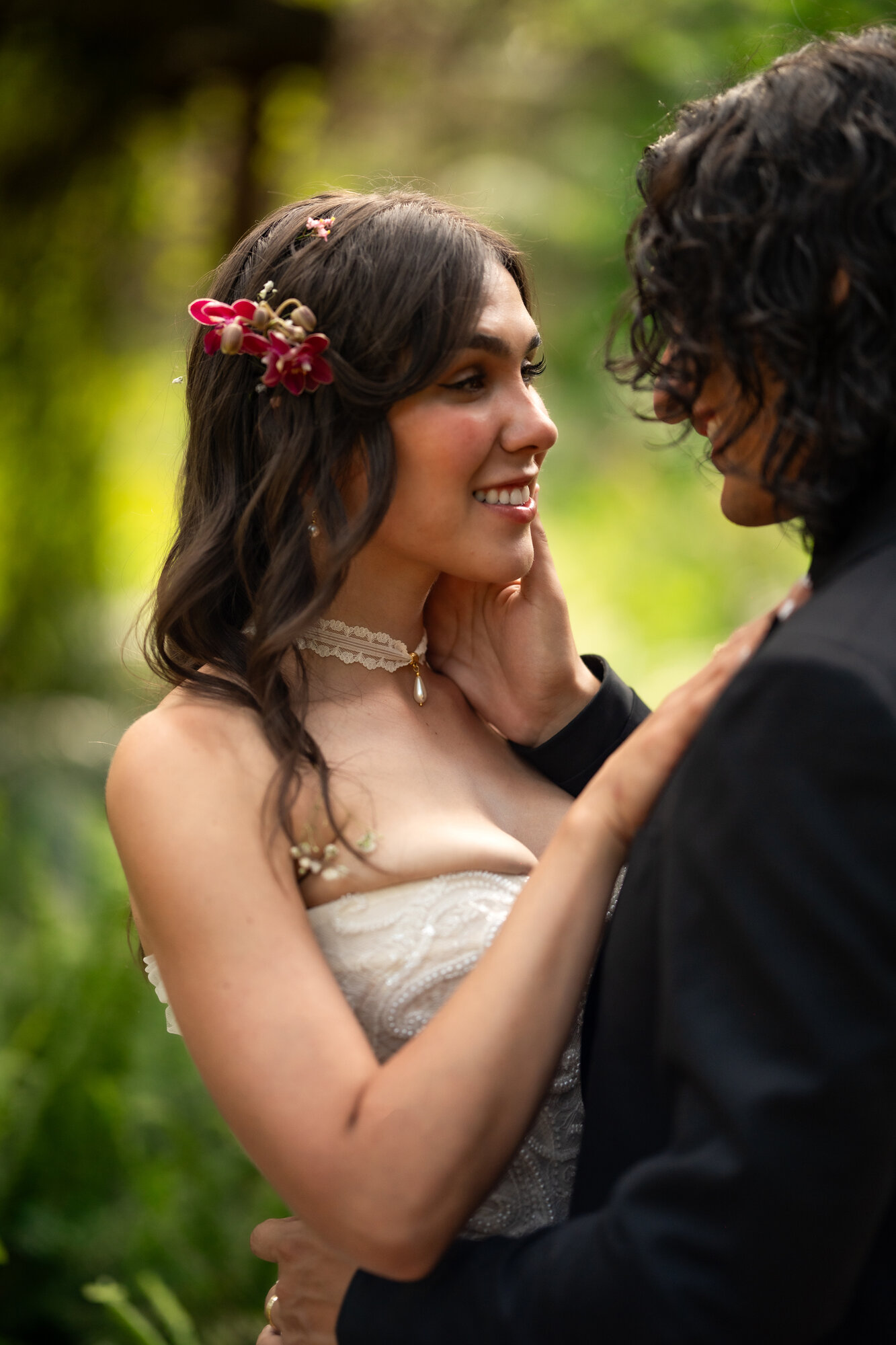 Couple walking hand in hand through tropical gardens after the ceremony