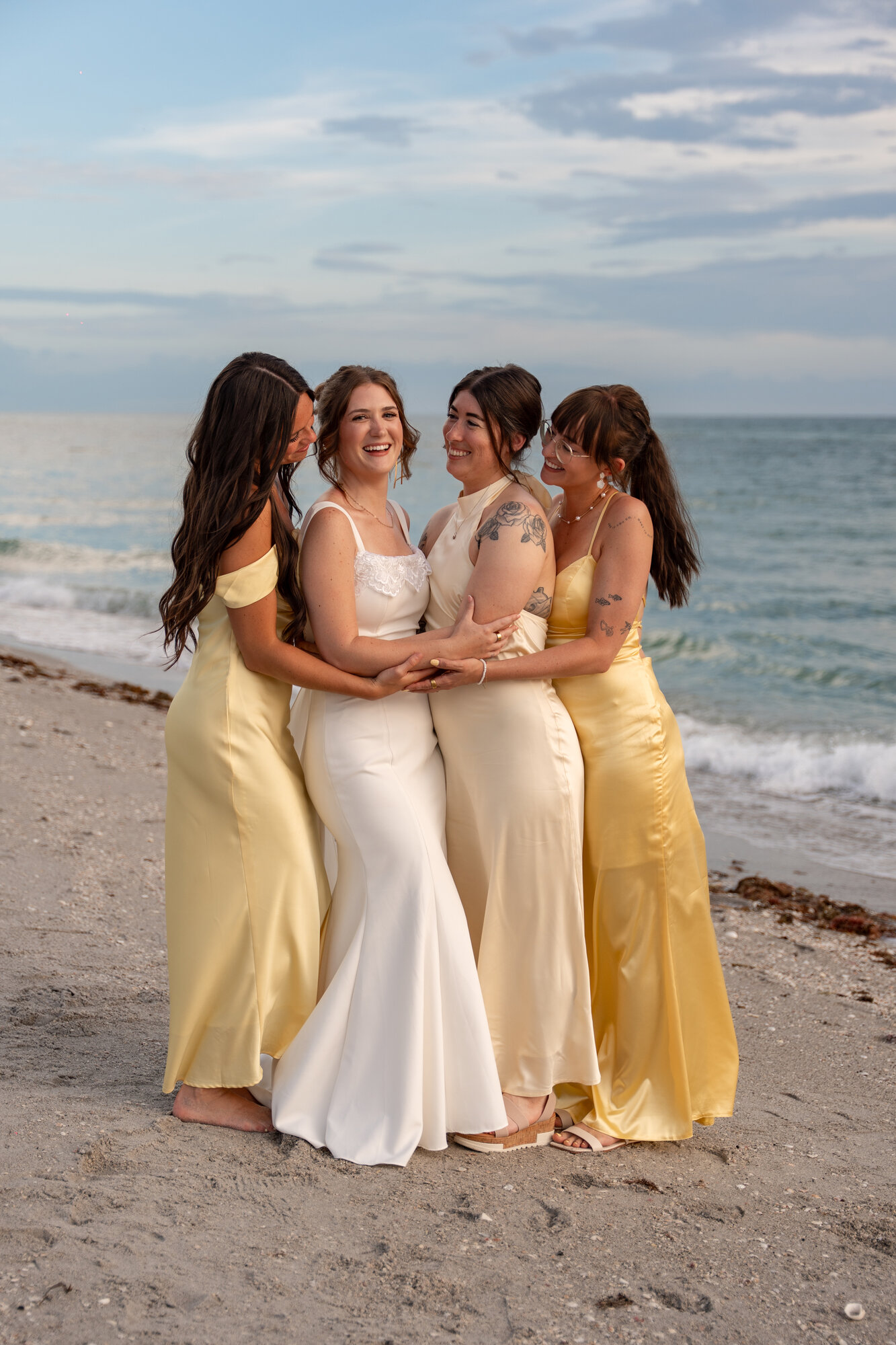 Destination wedding couple embracing on the beach at sunset